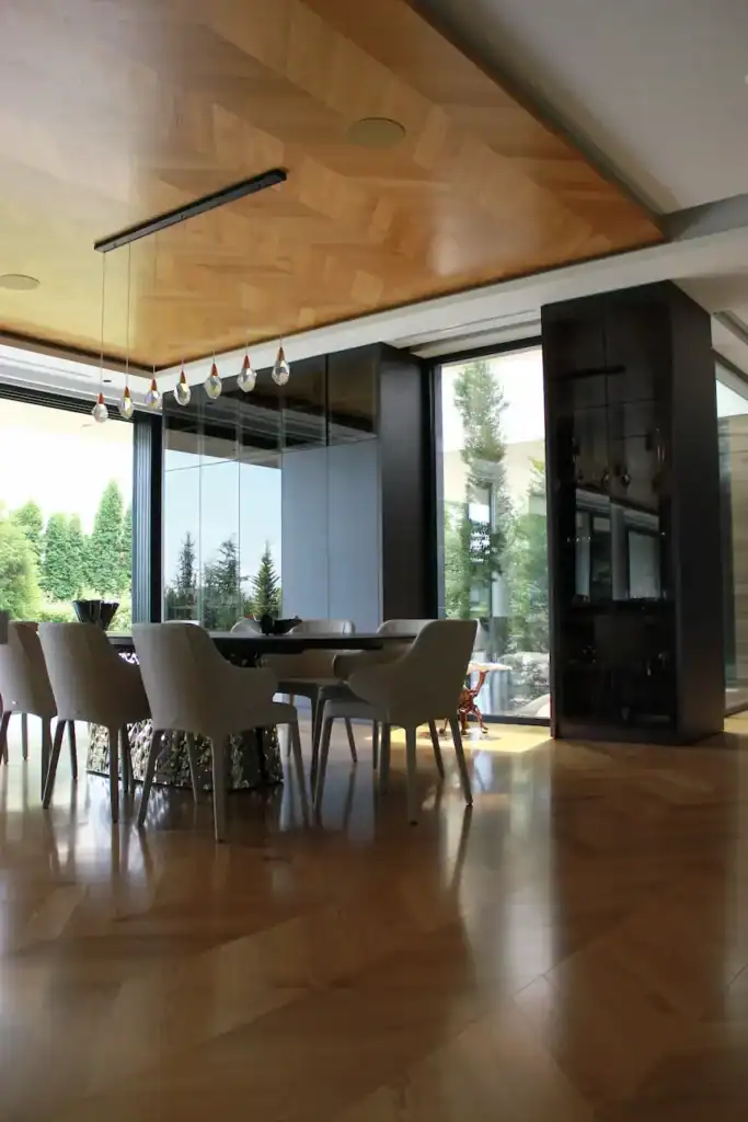 Elegant dining area featuring parquet design on both floor and ceiling